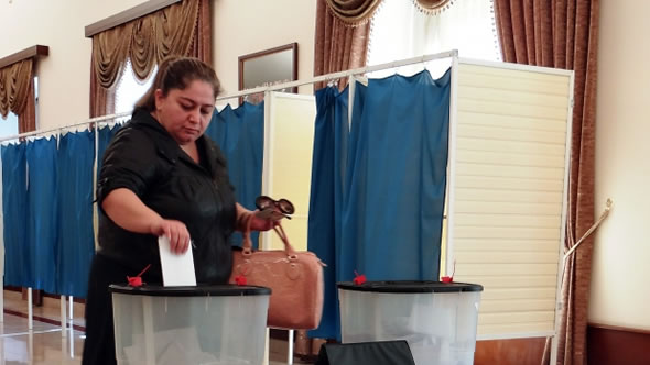 A voter casting her ballot at a polling station in Baku during presidential elections in Azerbaijan, 9 October 2013. Photo: ODIHR